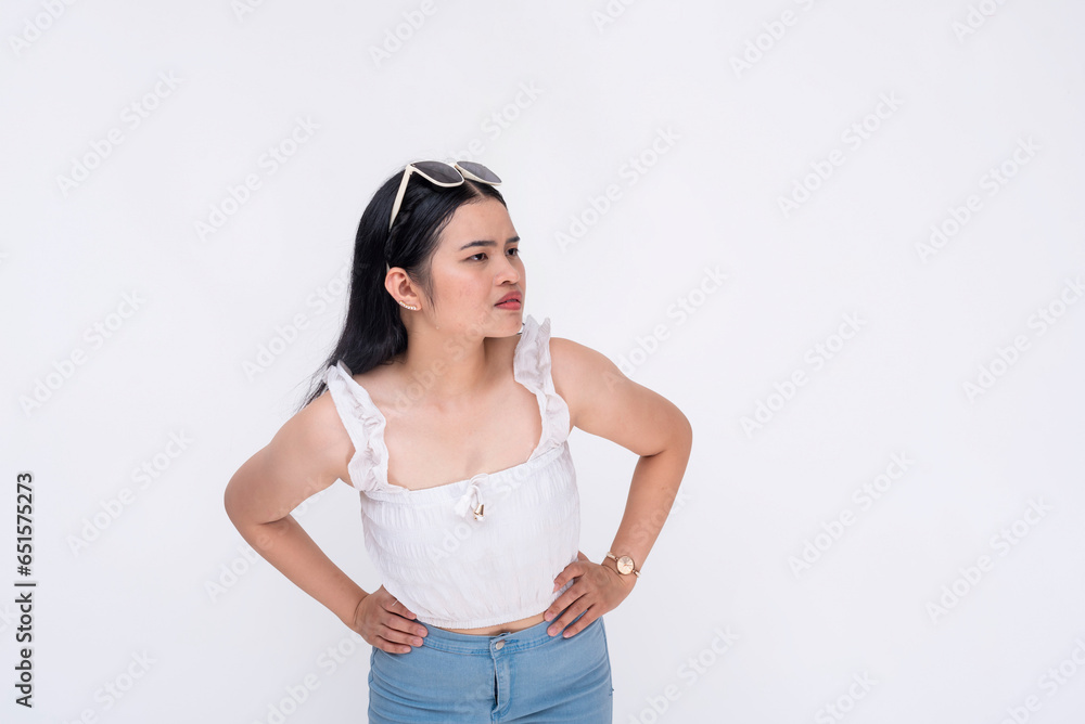 A curious young lady leans forward notices something from afar from her right. Trying to get a better view. Hands on waist. Isolated on a white backdrop. A curious young lady leans forward notices something from afar from her right. Trying to get a better view. Hands on waist. Isolated on a white backdrop.