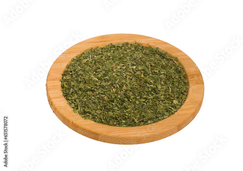 plate with dried parsley on a white background