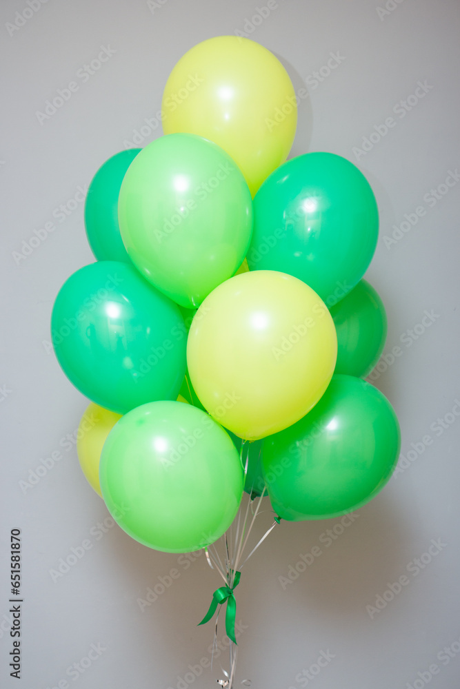 a bunch of green and light green balloons with helium on a white background, birthday a bunch of green and light green balloons with helium on a white background, birthday