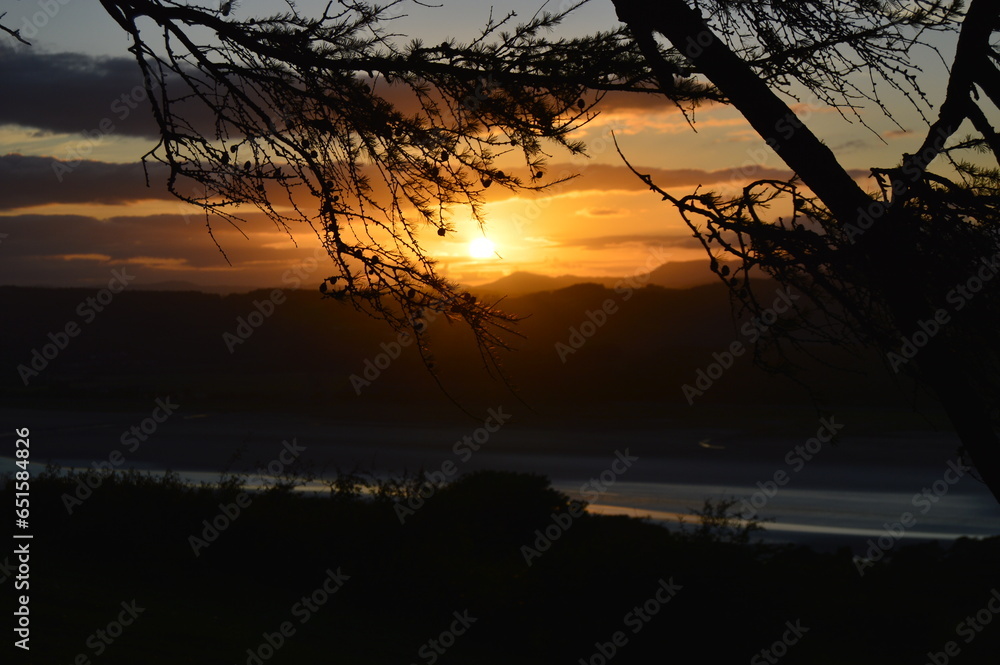 A beautiful Sunset appearing from behind the trees, viewed from Arnside Knott. A beautiful Sunset appearing from behind the trees, viewed from Arnside Knott.