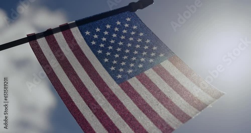 Miniature American flag against blue sky