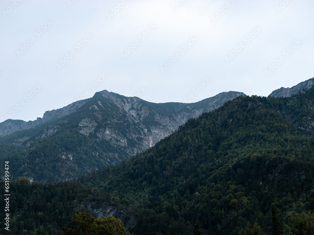 Mountain landscape with trees and big rocks in the Bavarian Alps in Europe. Beautiful nature of the famous travel destination in the south of Germany. Mountain landscape with trees and big rocks in the Bavarian Alps in Europe. Beautiful nature of the famous travel destination in the south of Germany.