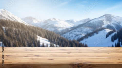 empty wooden table for display with snow mountain background © MAXXIMA Graphica