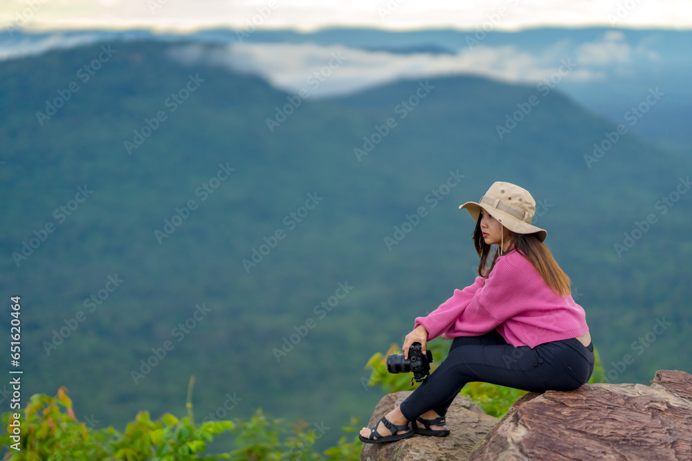 ourist Woman sitting and taking photos at Pha Mo E Daeng