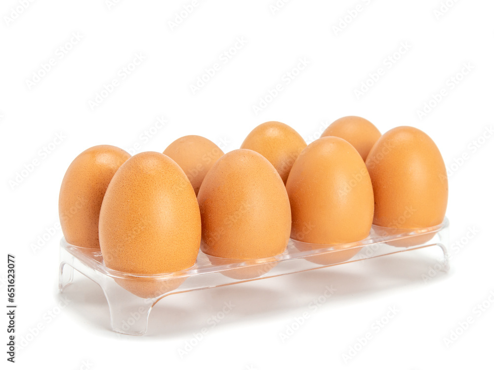 Chicken eggs in transparent plastic trays isolated on white. Chicken eggs are eaten for breakfast. Chicken eggs in transparent plastic trays isolated on white. Chicken eggs are eaten for breakfast.
