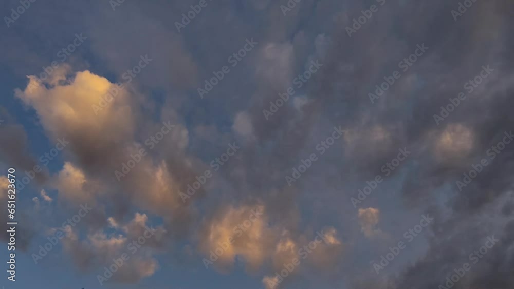 Sunset sky with orange clouds moving