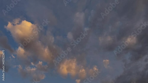 Sunset sky with orange clouds moving photo