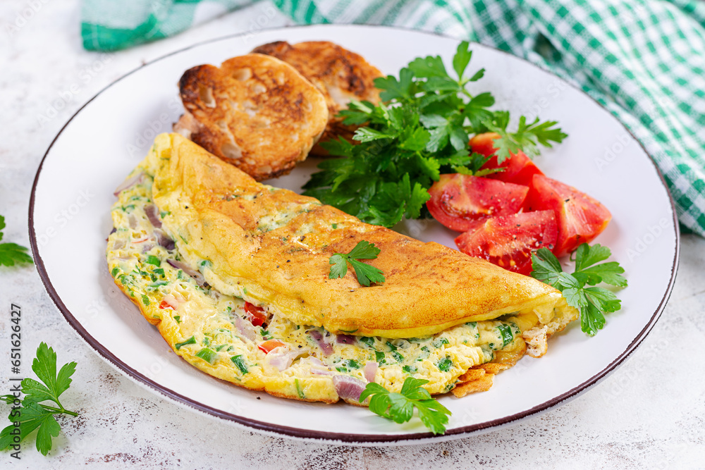 Omelette with tomatoes, cheese and red onion on white plate. Frittata - italian omelet. Omelette with tomatoes, cheese and red onion on white plate. Frittata - italian omelet.