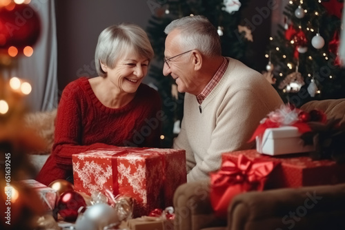 An elderly couple, a man and a woman, are packing gifts for their family. Christmas atmosphere of happiness