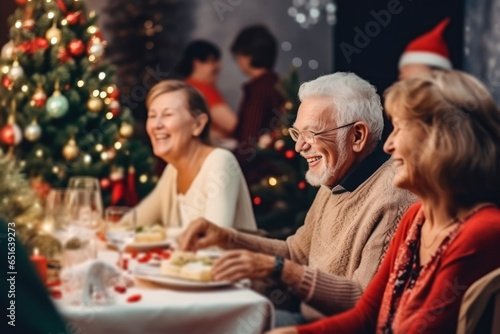 An elderly couple, a man and a woman, sit at the Christmas table. Christmas atmosphere of happiness