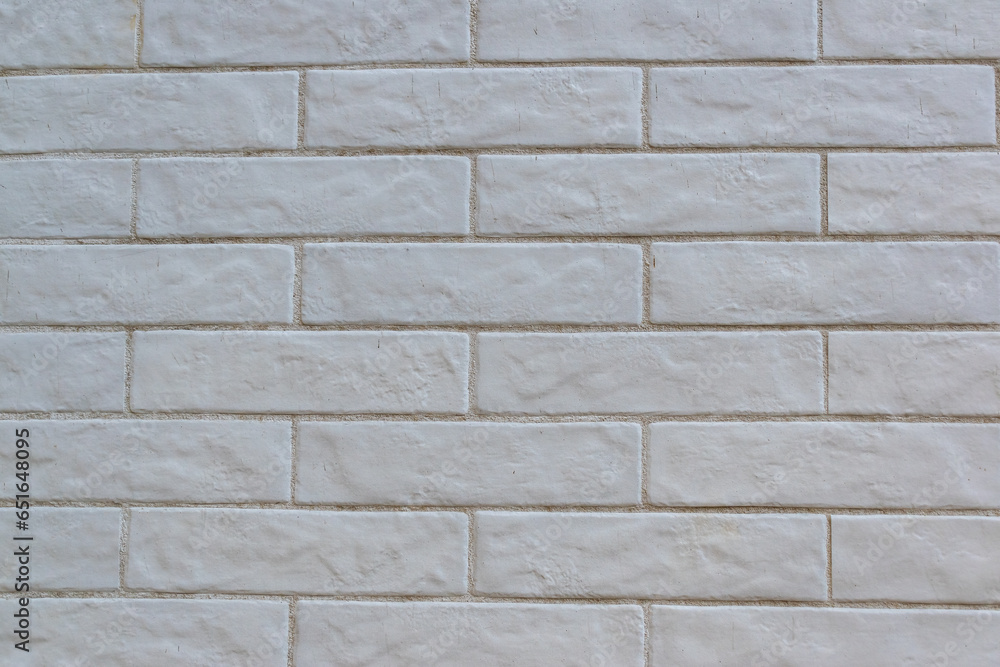 Horizontal cladding imitating brick painted white Horizontal cladding imitating brick painted white