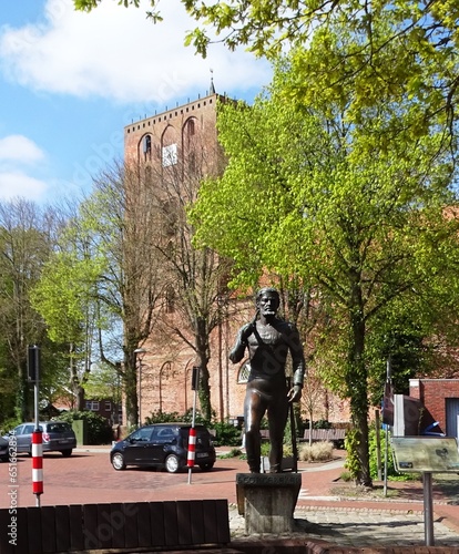 Bronce statue of the pirate Klaus Störtebeker in front of the church of Marienhafe (eastern Frisia) photo