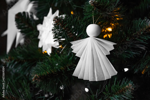 Origami decorations for the Christmas tree. Handmade, hobby Christmas tree toys. Paper crafts, handcrafts, homemade, handworks. Postcard, background for Christmas and new year. Angel and snowflake. photo