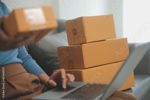 Business woman start up small business entrepreneur SME success .freelance woman working at home with Online Parcel delivery. SME and packaging deliveryconcept © Phanphen