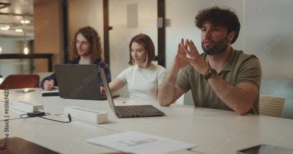 Business team discussing innovative ideas and plans. Multiracial team brainstorm late at night in modern office. Business team discussing innovative ideas and plans. Multiracial team brainstorm late at night in modern office.