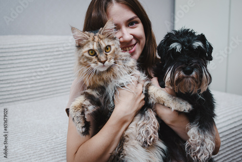 dog and a cat in the hands of their owner
