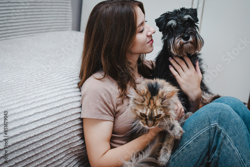 dog and a cat in the hands of their owner