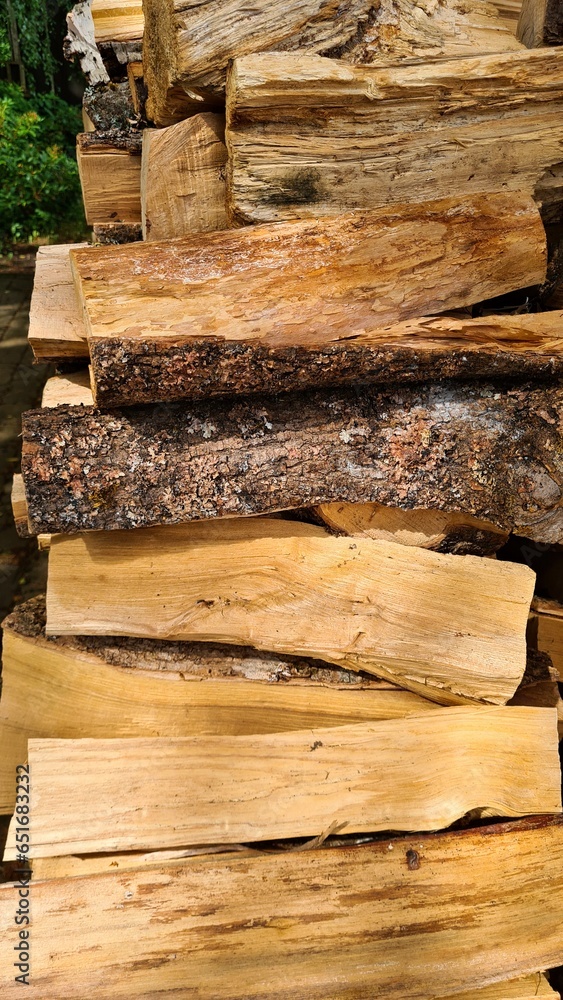 Stacked chopped wood is prepared for the stove in the village for the winter