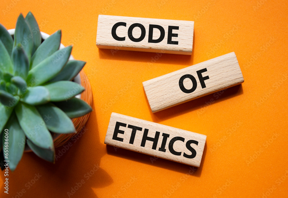 Code of ethics symbol. Concept words Code of ethics on wooden blocks. Beautiful orange