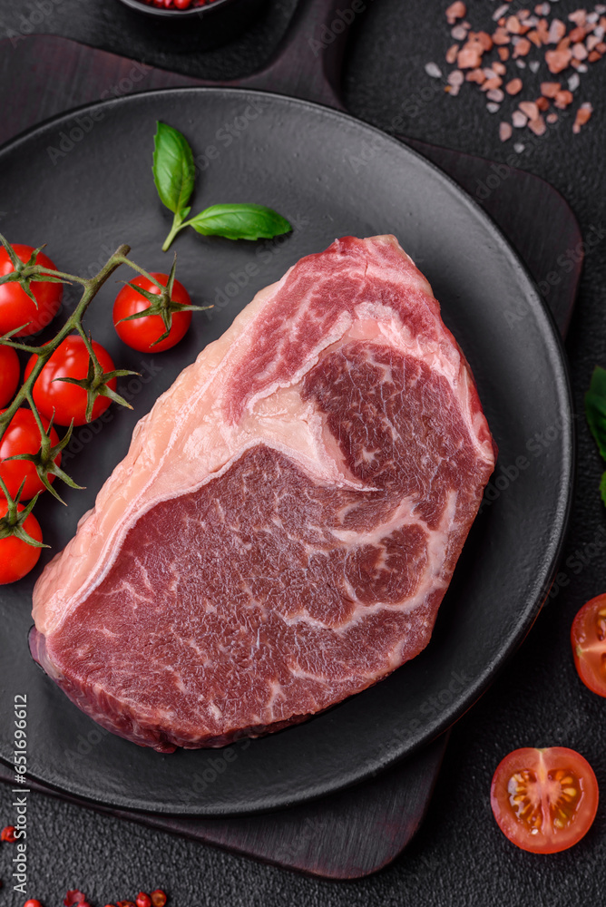 Fresh raw beef striploin steak with salt, spices and herbs Fresh raw beef striploin steak with salt, spices and herbs