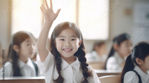 Happy Asian girl student raising hand in classroom, children active study in school, School children sitting at the desk in classroom on the lesson, raising hands photo