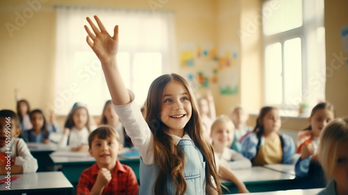 Happy girl student raising hand in classroom, children active study in school, School children sitting at the desk in classroom on the lesson, raising hands photo