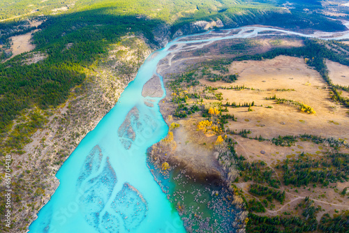 A drone view of the river in the mountains valley. An aerial view of an autum...