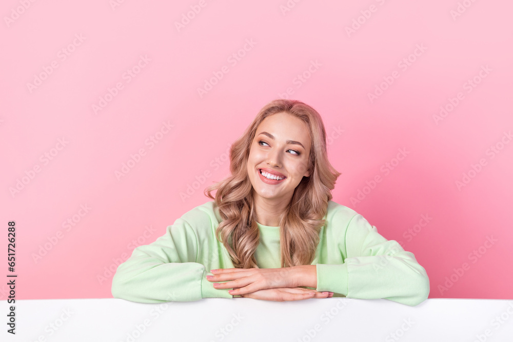 Portrait of lovely cheerful lady toothy smile look empty space advert billboard isolated on pink color background Portrait of lovely cheerful lady toothy smile look empty space advert billboard isolated on pink color background