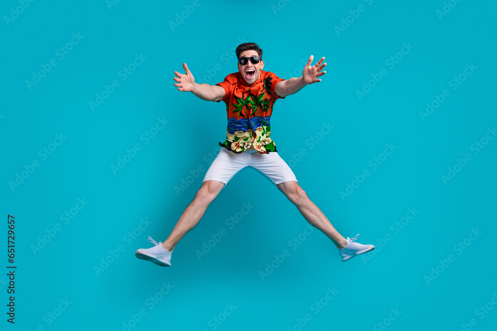 Full size body photo of careless jumping up opened hands missing you guy have fun tropical print shirt isolated on blue color background