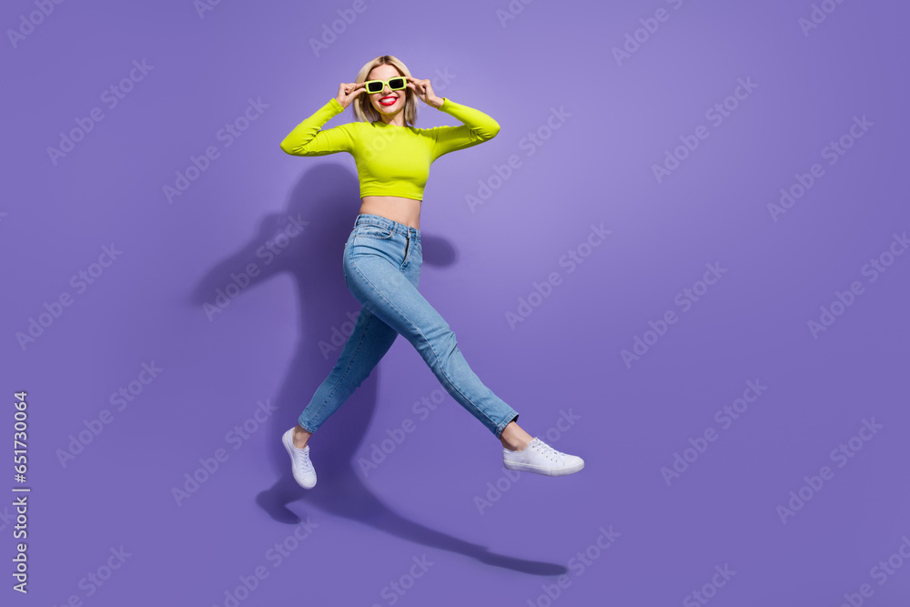 Full length photo of optimistic girl wear stylish clothes going store center seasonal sale empty space isolated on purple color background