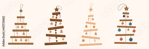 Collection of Handmade eco Christmas tree made of wooden planks on a rope hanging on the wall. Organic decorations. Zero waste plastic free concept. Ecological holiday. Ecofriendly decor