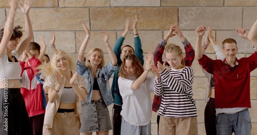 Vászonkép Group of young people Jumping and clapping hands, expressing happiness joy excitement