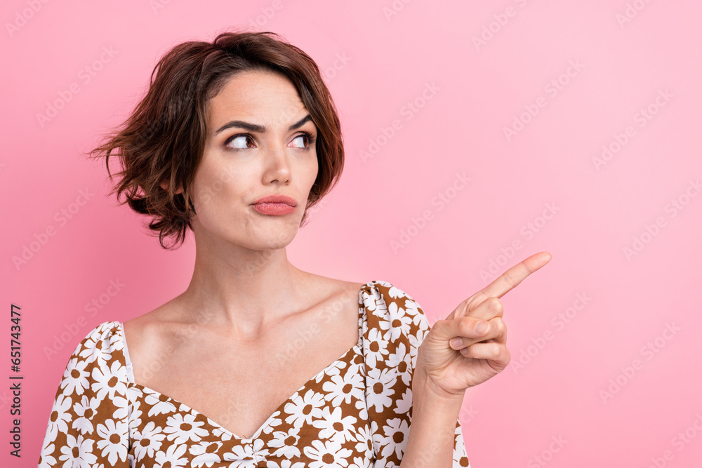 Photo of funny strict thoughtful young lady pouty lips directing finger novelty distrust that information isolated on pink color background Photo of funny strict thoughtful young lady pouty lips directing finger novelty distrust that information isolated on pink color background