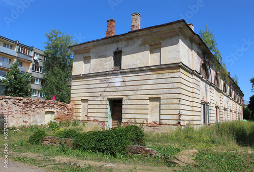 Abandoned building at Daugavpils Fortress with a Soviet era apartment building nearby photo