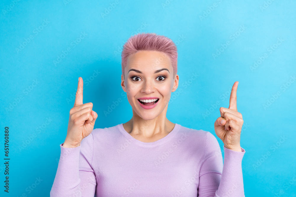 Photo of overjoyed lady open mouth directing fingers empty space awesome ads adv ad offer isolated blue color background Photo of overjoyed lady open mouth directing fingers empty space awesome ads adv ad offer isolated blue color background