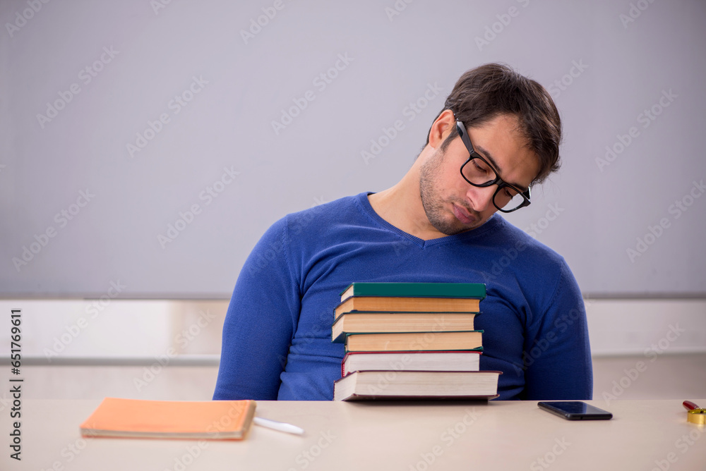 Young male student preparing for exams in the classroom Young male student preparing for exams in the classroom