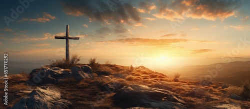 Jesus Christ crucified on a hill with a sunset backdrop