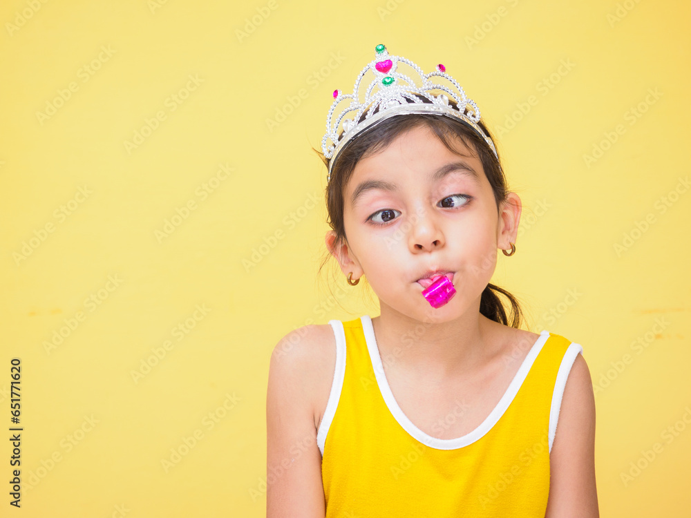 white girl making facial expressions with carnival crown yellow background white girl making facial expressions with carnival crown yellow background