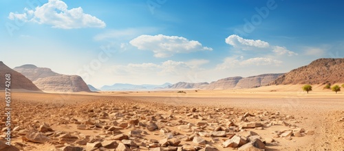 Hiking in the dry hot Israeli desert with a mountain to climb and a sunny day