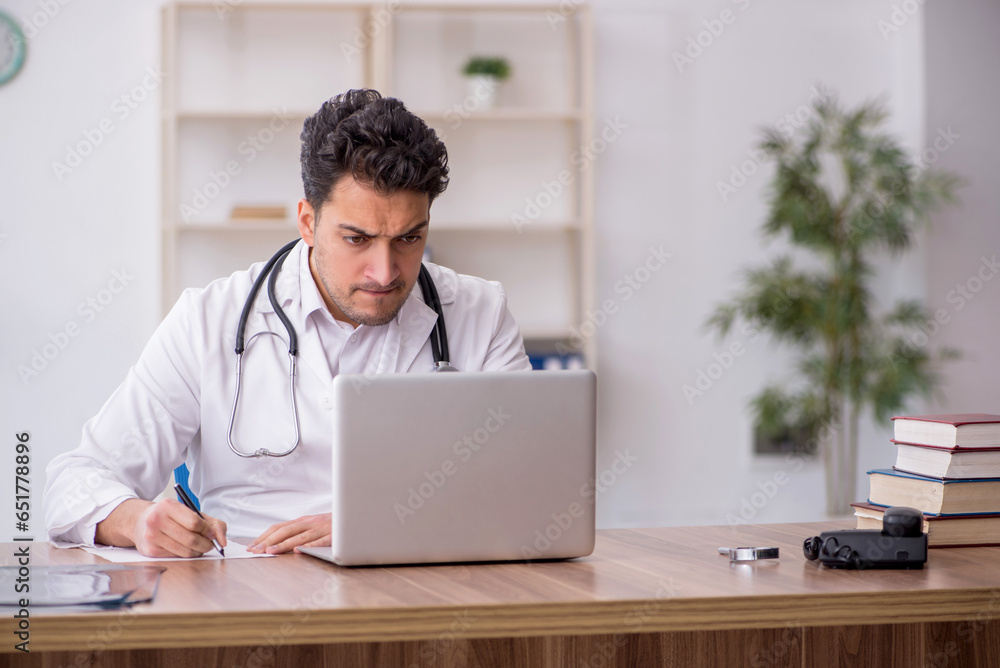 Young male doctor in telemedicine concept Young male doctor in telemedicine concept