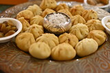 Beautiful Plate with the lovely fried Modak. Sweets for Lord Ganesha. Silver Bowl with coconut and sugar. Prasad for Lord Ganesha. Chaturthi festival Chaturdashi festival Visarjan Pooja. Diwali modak