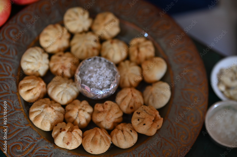 Beautiful Plate with the fried Modak. Sweets for Lord Ganesha. Silver Bowl with coconut and sugar. Prasad for Lord Ganesha. Chaturthi festival Chaturdashi festival Visarjan Pooja of lord Ganesha Beautiful Plate with the fried Modak. Sweets for Lord Ganesha. Silver Bowl with coconut and sugar. Prasad for Lord Ganesha. Chaturthi festival Chaturdashi festival Visarjan Pooja of lord Ganesha