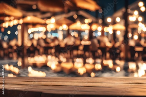 Wooden table with blur beach cafes background and bokeh lights .