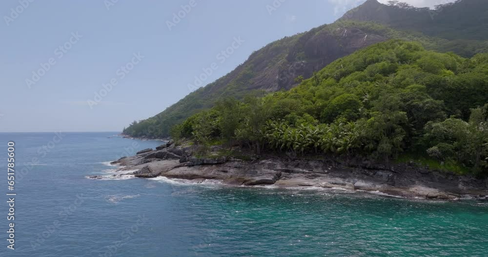 Aerial Panning Shot Of Mountains With Trees Near Ocean At Sunny Day - Praslin, Seychelles Aerial Panning Shot Of Mountains With Trees Near Ocean At Sunny Day - Praslin, Seychelles