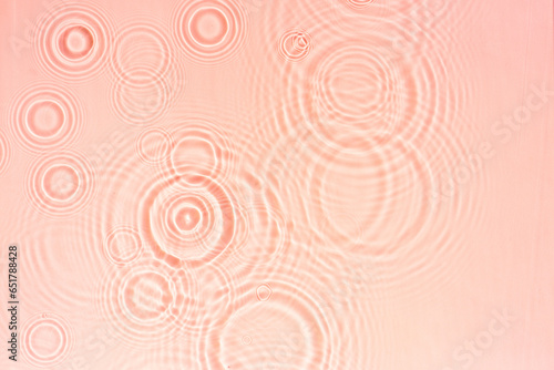 Pink transparent water texture with circles from drops