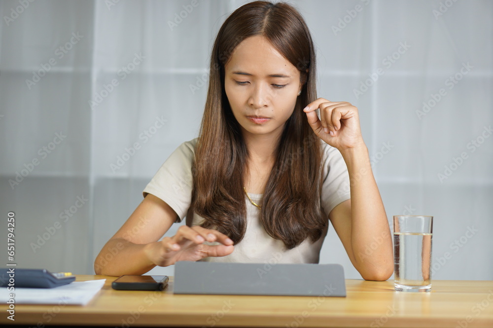 Asian woman working at home Stressed from the loss of business Asian woman working at home Stressed from the loss of business