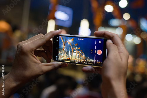 Photography Person using phone camera to record Ganga Arti, Varanasi