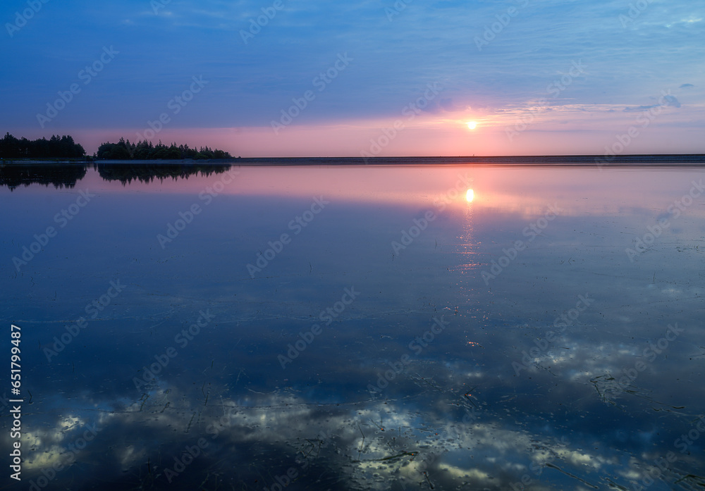 sunrise over the lake with reflection in the water