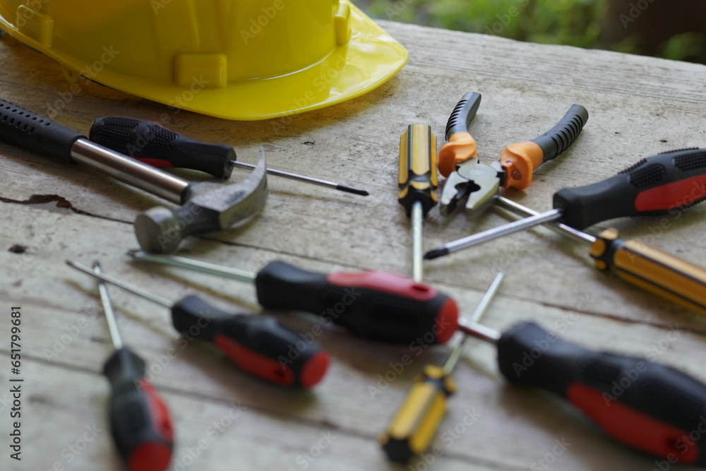 Set of professional construction tools and safety helmet on work table. Top view. Old tools. Various tools on a wooden table Set of professional construction tools and safety helmet on work table. Top view. Old tools. Various tools on a wooden table