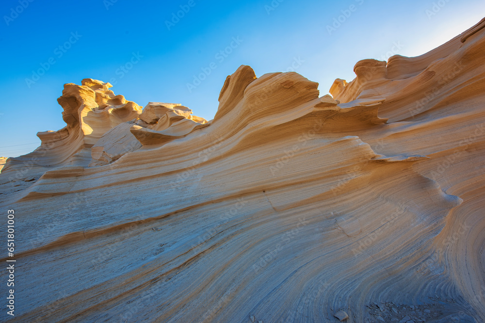 Desert eroded rock pattern with clear sky. Desert rock formation with erosion